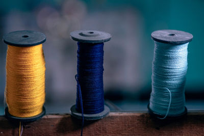 Close-up of threads spools on table 