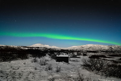 Scenic view of snowcapped mountains against sky at night