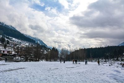 Panoramic view of trees on snow covered mountains against sky