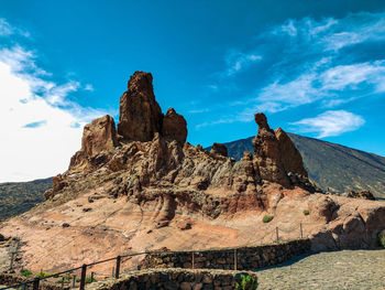 Rock formations on landscape against sky