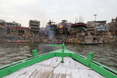 River amidst buildings in city against sky