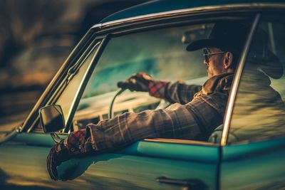 Man sitting in car at night