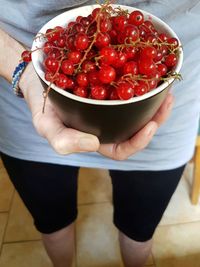 Midsection of woman holding currants 