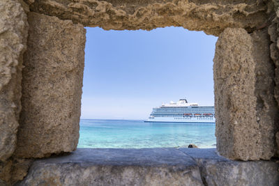 Scenic view of sea and ship or boat against sky