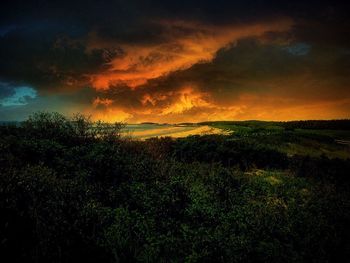 Scenic view of landscape against cloudy sky