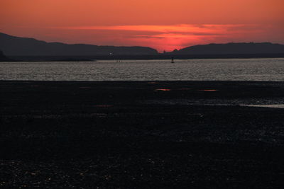 Scenic view of sea against romantic sky at sunset