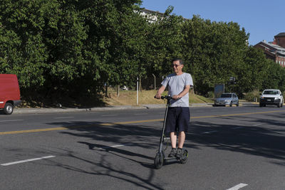 Rear view of man walking on road