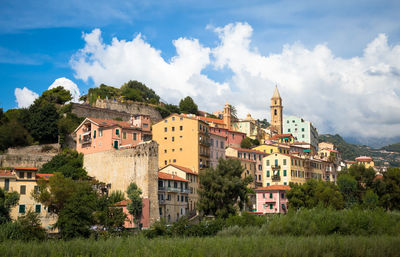 Buildings against cloudy sky