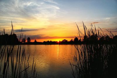 Scenic view of lake against orange sky