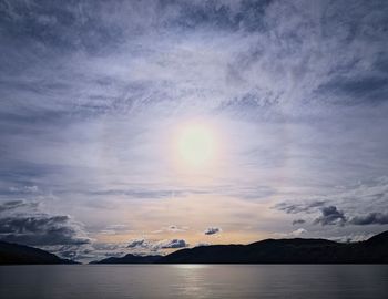 Scenic view of mountain range against cloudy sky