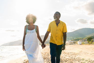 Rear view of couple standing against sky