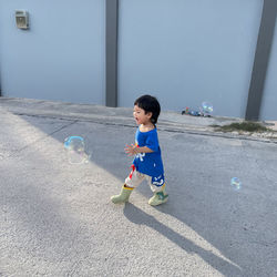 Boy playing with ball at beach