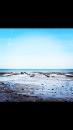 Scenic view of sea against blue sky