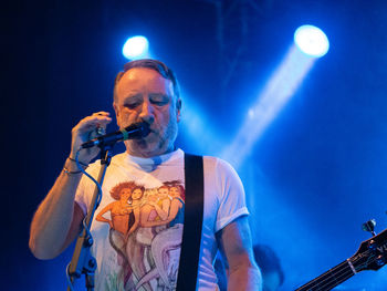 Man holding illuminated lighting equipment at night