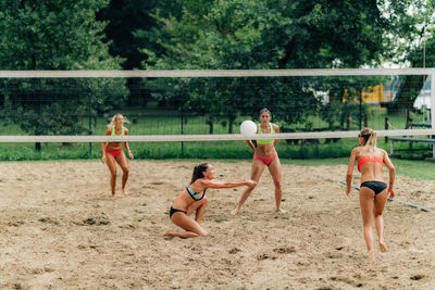 Young women playing beach volleyball