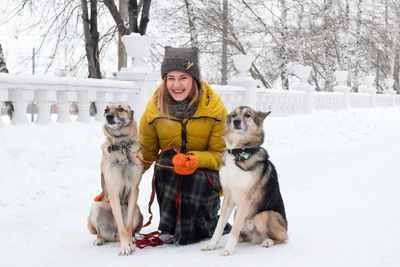 Woman with dogs on snow covered street