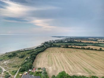 Scenic view of land and sea against sky