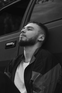 Portrait of young man sitting in car