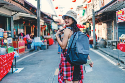 Full length of woman standing on street in city