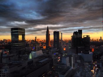 Skyscrapers against cloudy sky