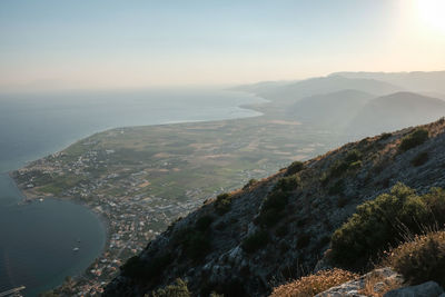 Aerial view of sea and mountains against sky