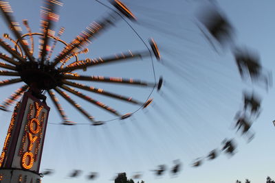 Blurred motion of chain swing ride at amusement park