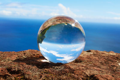 Close-up of crystal ball on rock