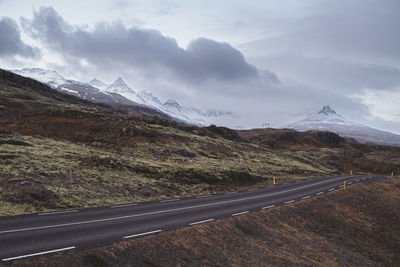 Road amidst mountains against sky