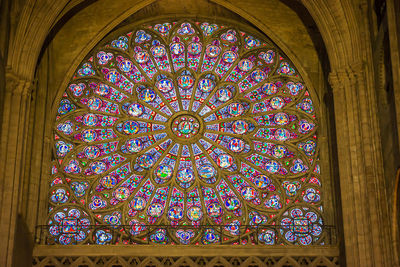 Low angle view of stained glass window in building