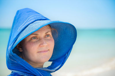 Portrait of mid adult man against blue sea