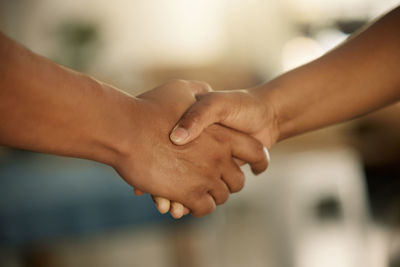 Cropped image of couple holding hands