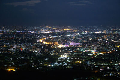 High angle view of illuminated buildings in city at night