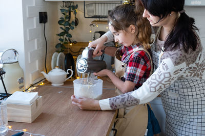 Side view of woman drinking coffee at home