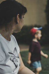 Rear view of mother and daughter outdoors