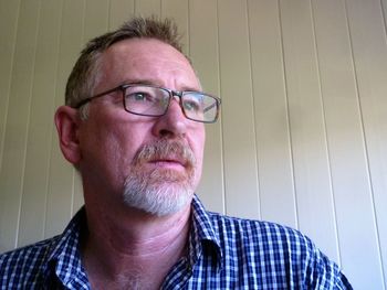 Close-up portrait of man wearing eyeglasses