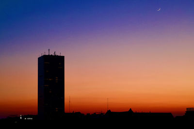 Low angle view of buildings against sky during sunset