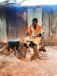 Full length of man sitting on table
