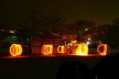 Illuminated christmas lights in city at night