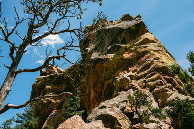 Low angle view of rock formation against sky