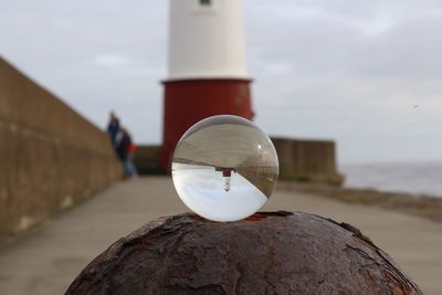 View of lighthouse through lens ball