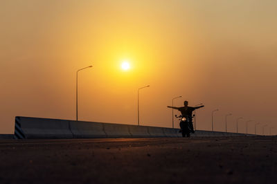 Young man riding big bike motocycle on asphalt high way against, motorbike man has freedom