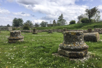 View of old ruin on field against sky