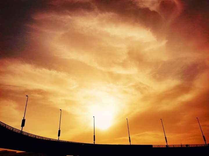 sunset, sky, orange color, cloud - sky, built structure, architecture, dramatic sky, cloudy, silhouette, low angle view, beauty in nature, scenics, nature, cloud, outdoors, weather, street light, no people, connection, overcast