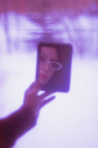 Close-up of person hand holding smart phone outdoors