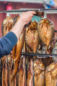 Hanging smoke-dried fish in a fish market smoked with hardwood wood chips in a smoker, ready to eat