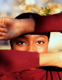 Close-up portrait of young woman with open book