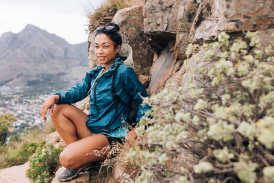 Young woman sitting on rock