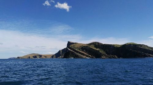 Scenic view of sea against blue sky