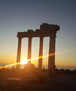 Sun shining over sea during sunset