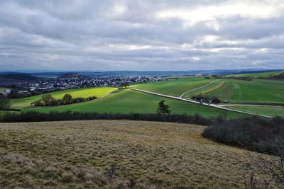 Scenic view of agricultural field against sky